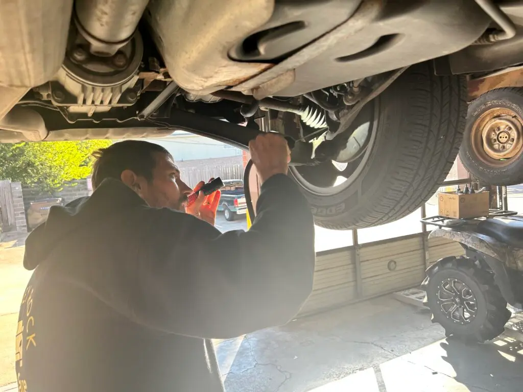 vehicle inspection during oil change in Houston checking undercarriage components
