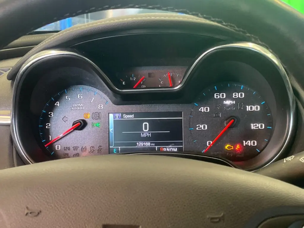 Multiple dashboard warning lights including check engine light