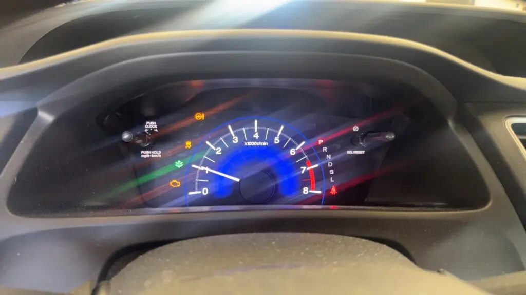 Check engine light and other warning lights illuminated on a vehicle dashboard