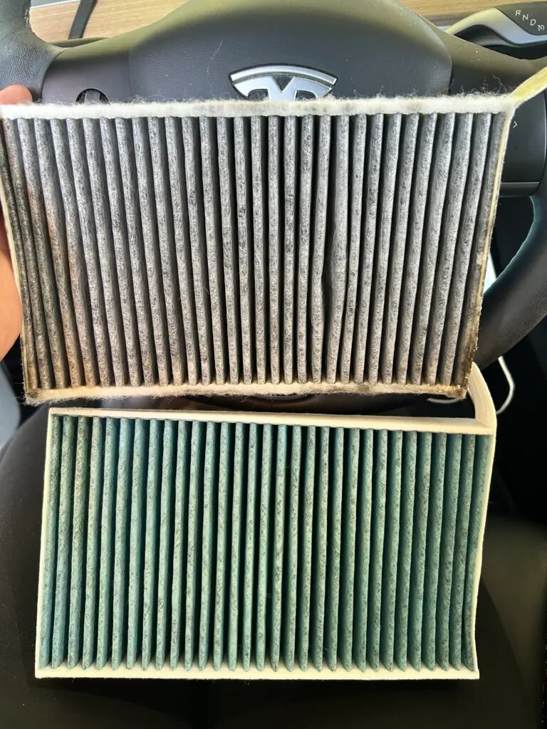 Dirty and new Tesla cabin air filter during electric vehicle maintenance service in Houston TX