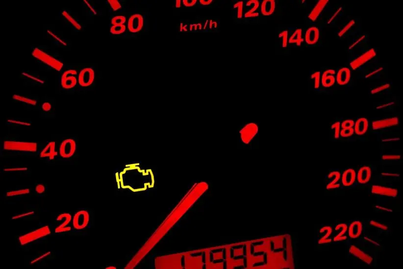 Check engine light illuminated on vehicle dashboard, indicating potential engine issues, relevant to vehicle maintenance tips and auto repair guidance.