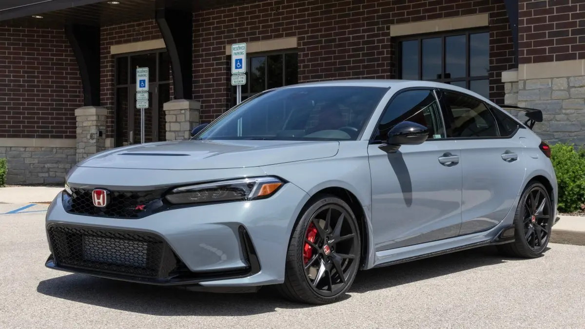 Honda Civic Type R parked outside Deutmeyer Auto Advantage, showcasing sleek design and sporty features, emphasizing Honda's engineering excellence in Dyersville, IA.