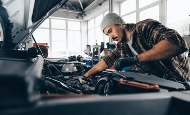 Mechanic examining car in auto car repair service center Mechanic examining car in auto car repair service center