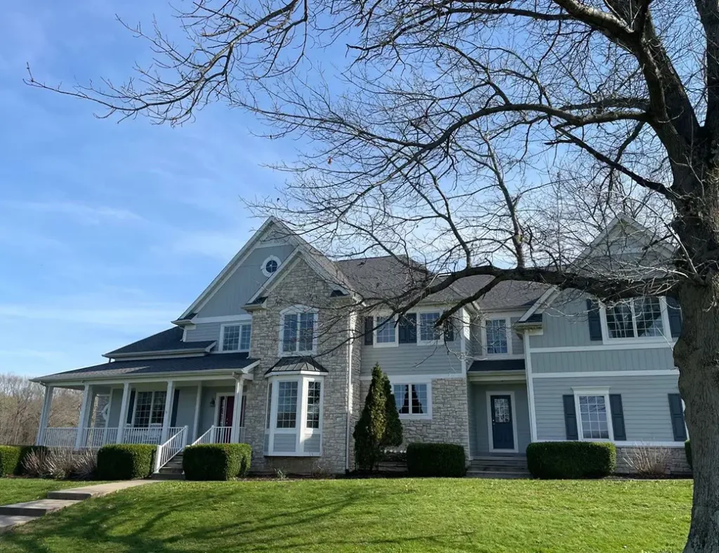 Stock photo of an upscale home with windows, siding, and roofing – used by Sutton’s for illustration