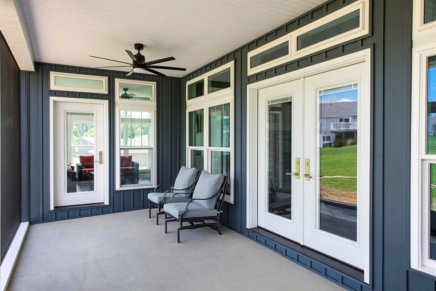 ProVia promo showing four white windows with transoms above, a double entry door, and a single door, all set against blue vertical siding – available from Sutton’s in Springfield IL