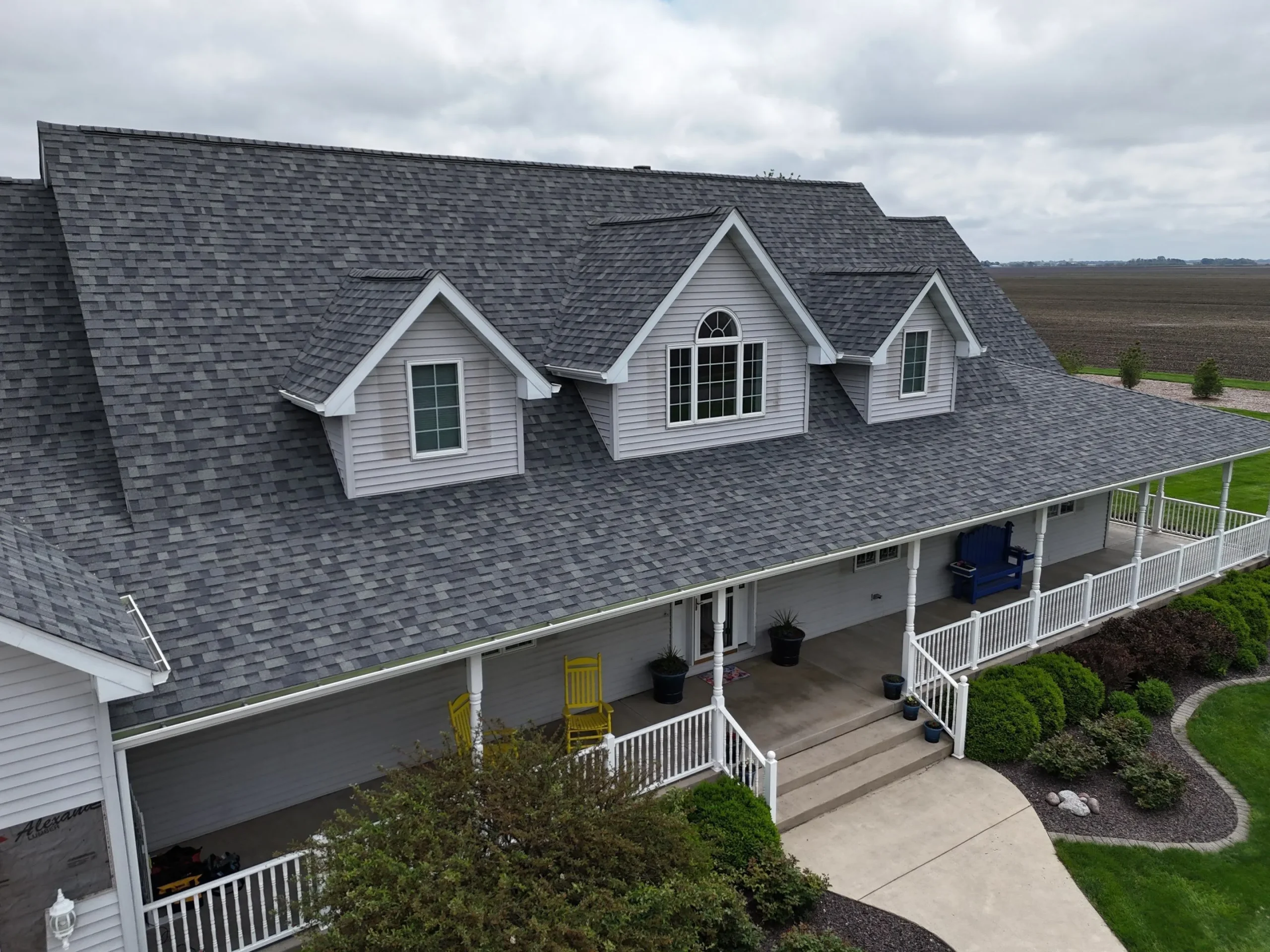 Aerial view of a new GAF shingle roof installed by Sutton's, one of the roofing contractors in Central Illinois homeowners have trusted since 1946