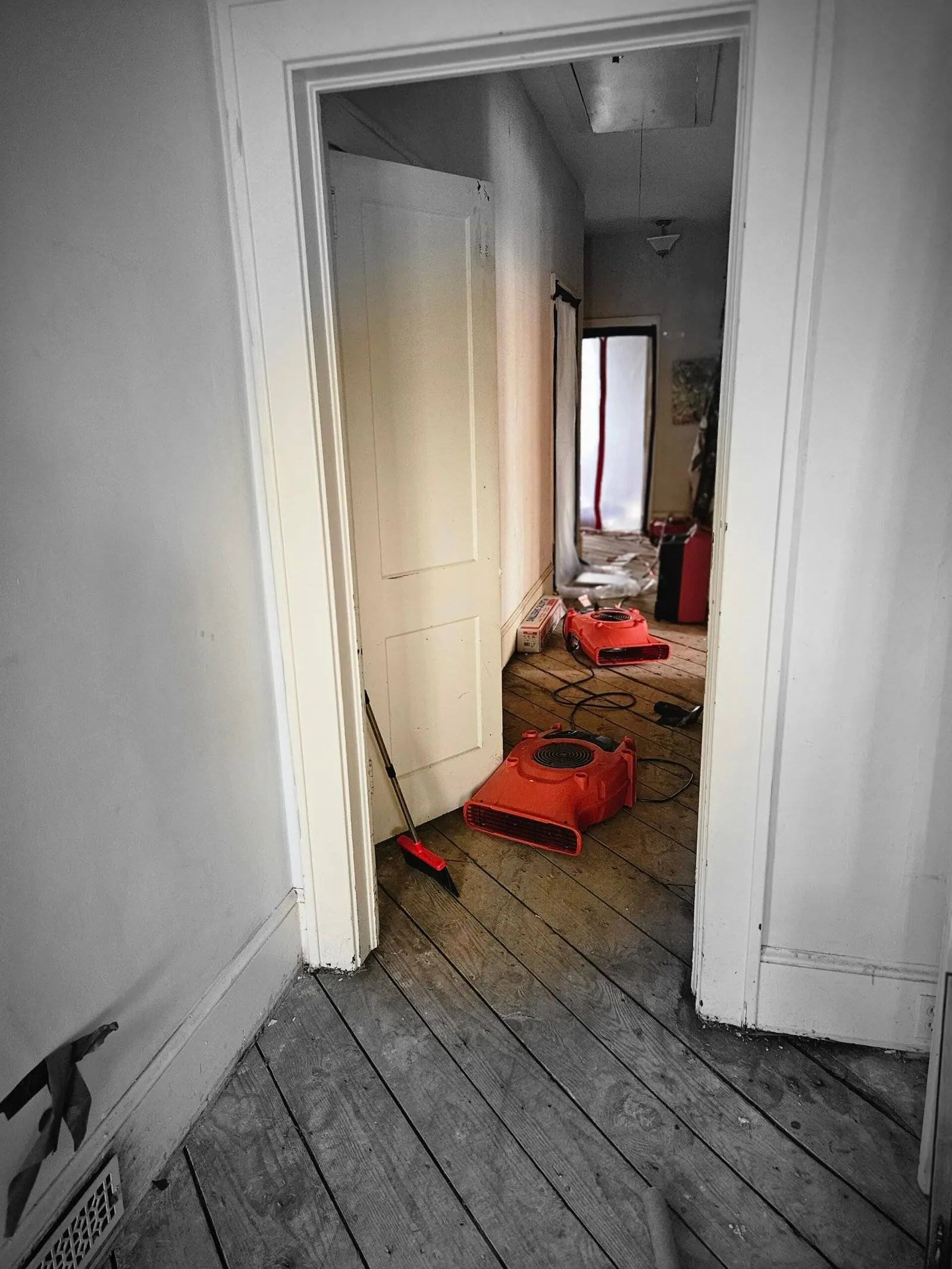 Hallway with drying equipment and water damage restoration tools, showcasing advanced restoration techniques for effective water mitigation.