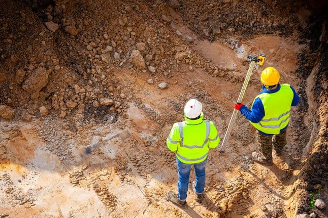 Surveyors at the construction site. View from above