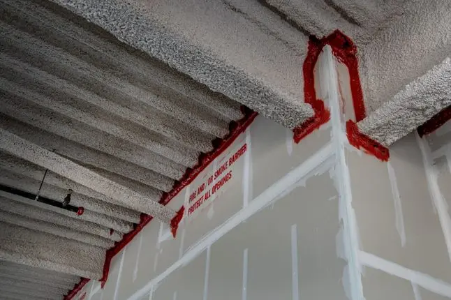 Fire barrier with noncombustible caulking.