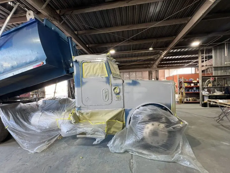Medium‑duty truck bodywork in garage
