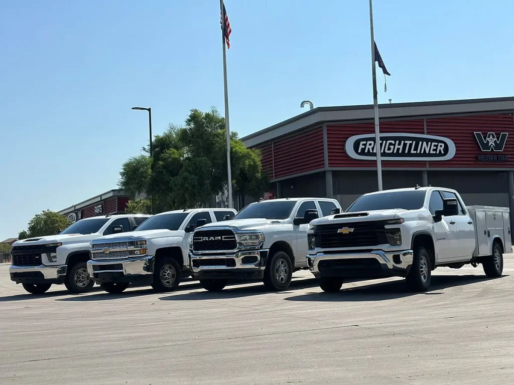 a row of white trucks in front of a building