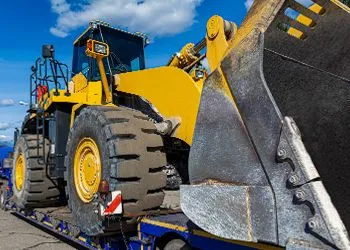 a yellow bulldozer on a flatbed