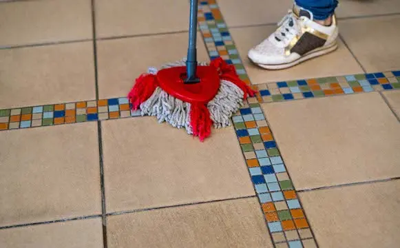 Mopping colorful and travertine tile flooring in Tucson