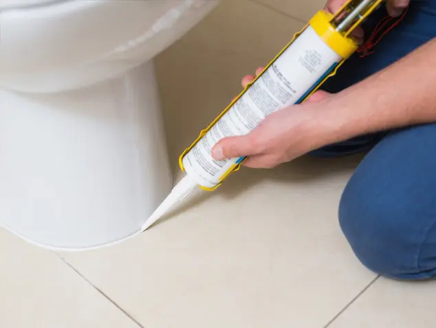 Tucson Tile and Grout recaulking a toilet
