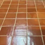 Close-up of clean, glossy Saltillo tile with evenly spaced grout lines, highlighting the tile's natural terracotta color and texture.