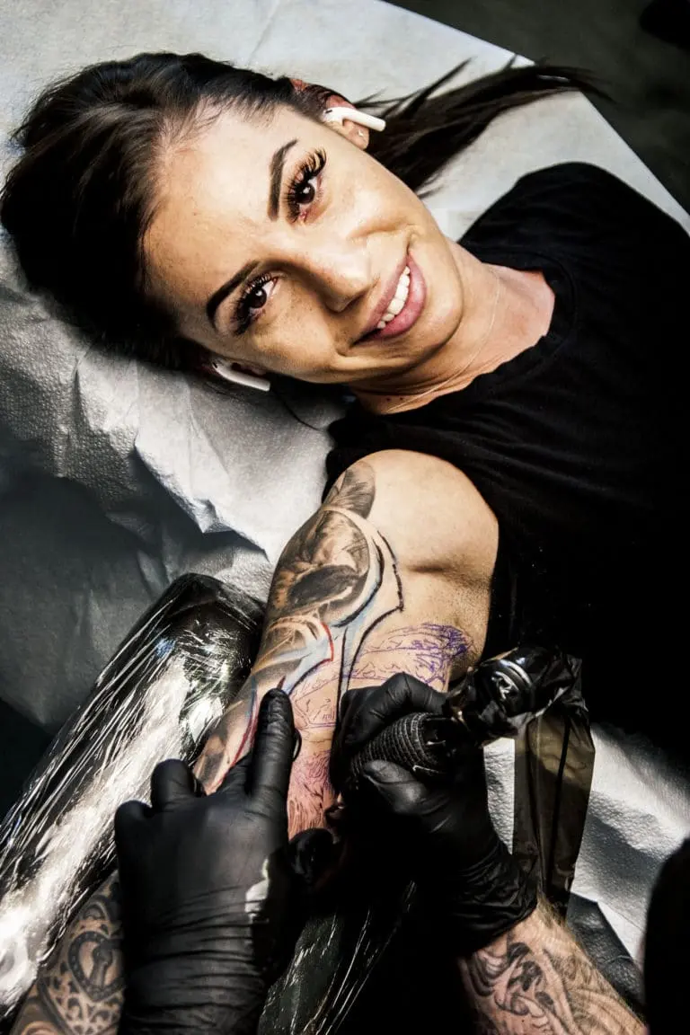 A client getting tattooed by Tyler