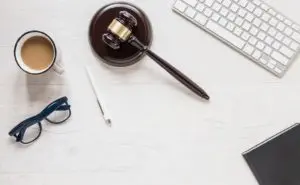 Gavel Keyboard Cup of Tea and Glasses on Table