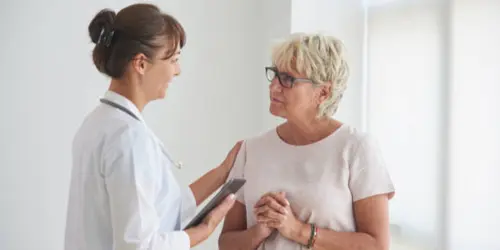 Florida car accident and workers’ comp doctor talking with patient at Select Injury Doctors in Florida