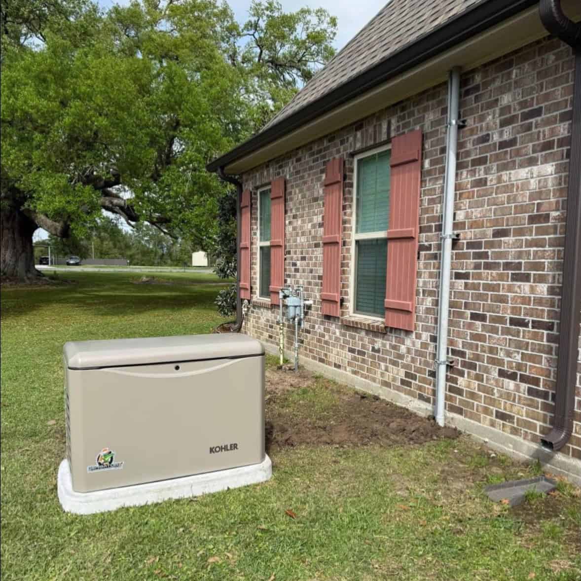 Kohler generator installed on grass next to home