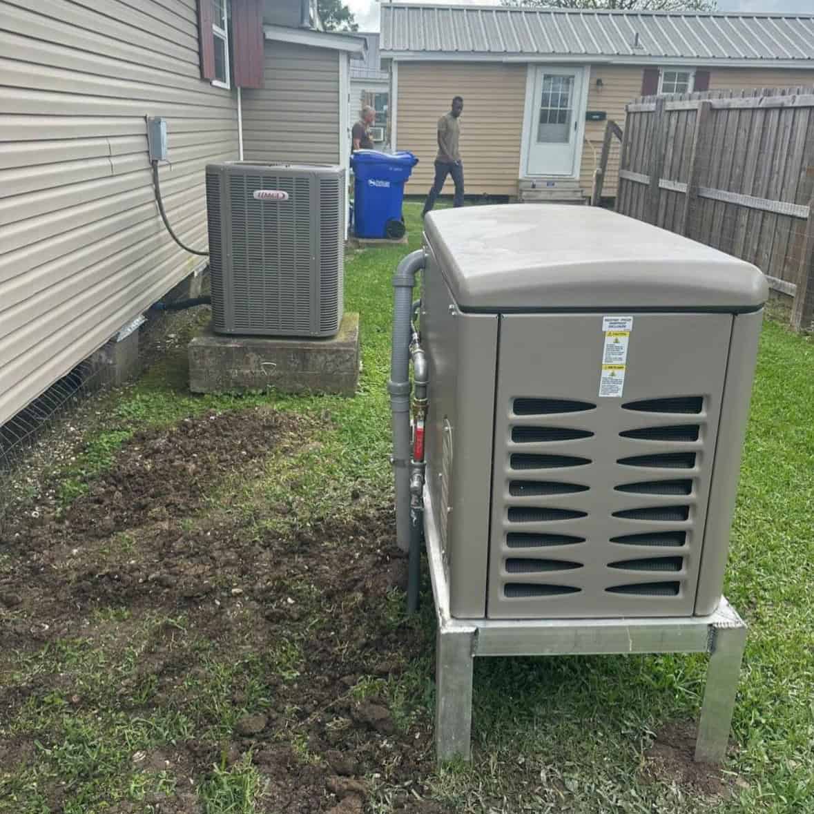 Houma generator 2 Generator and stand next to tan house