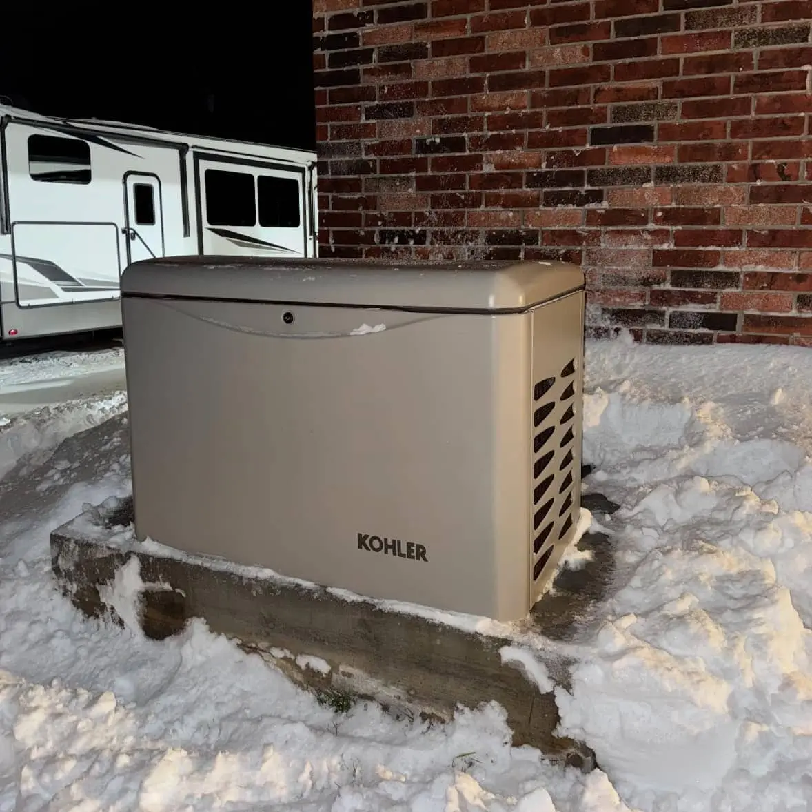Thibodaux, LA Kohler generator installed on snow next to brick house in Thibodaux