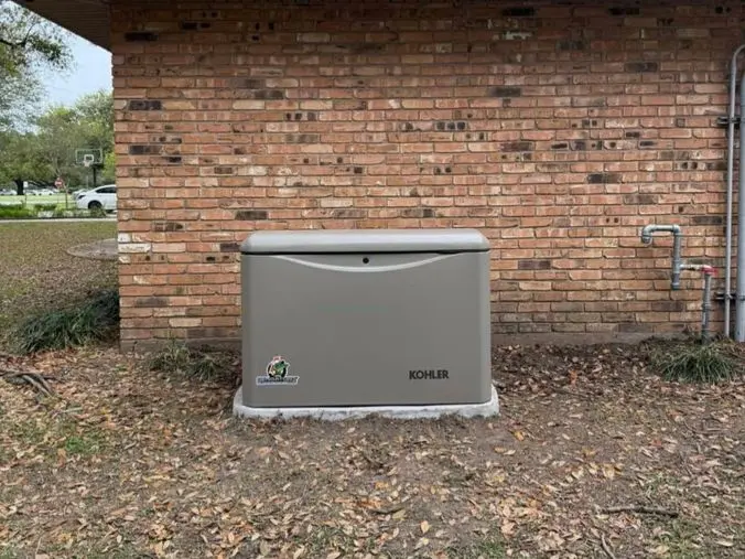 Kohler generator installed in front of brick house