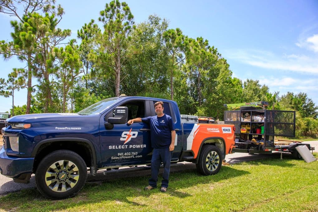 Select Power Technician With Service Truck And Equipment Trailer Select Power technician standing beside a branded service truck and equipment trailer in Florida