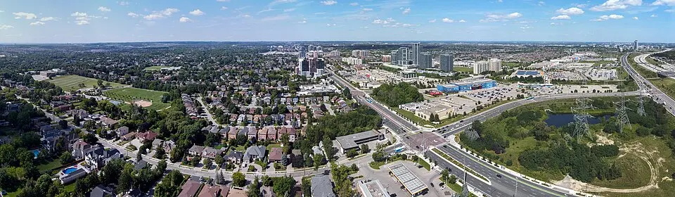 Aerial view of a suburban neighborhood with a highway and commercial area Takeoff-Moving Toronto