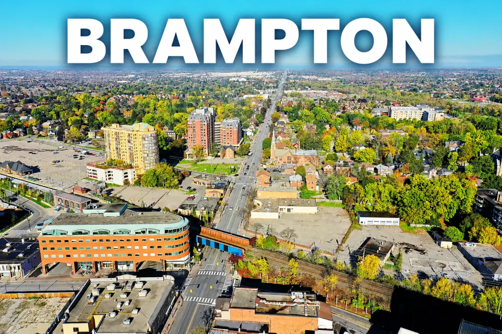 Aerial view of Brampton, Ontario, showing city skyline, streets, and autumn foliage. Takeoff-Moving Toronto
