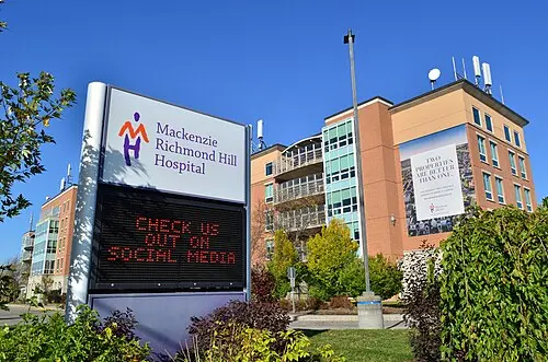 Mackenzie Richmond Hill Hospital sign with "CHECK US OUT ON SOCIAL MEDIA" LED display. Takeoff-Moving Toronto