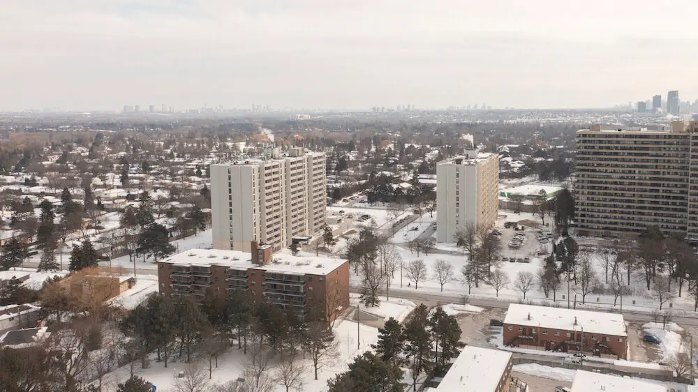 Winter scene of apartment buildings and houses in a suburban landscape. Takeoff-Moving Toronto
