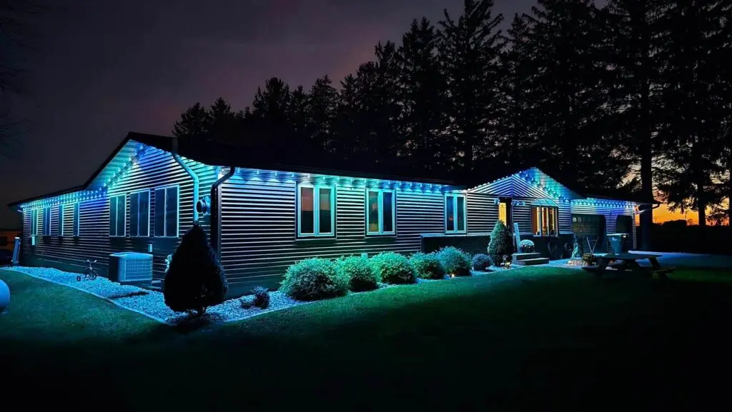 A residential home illuminated with blue and white LED holiday lights, in Fennimore, WI.