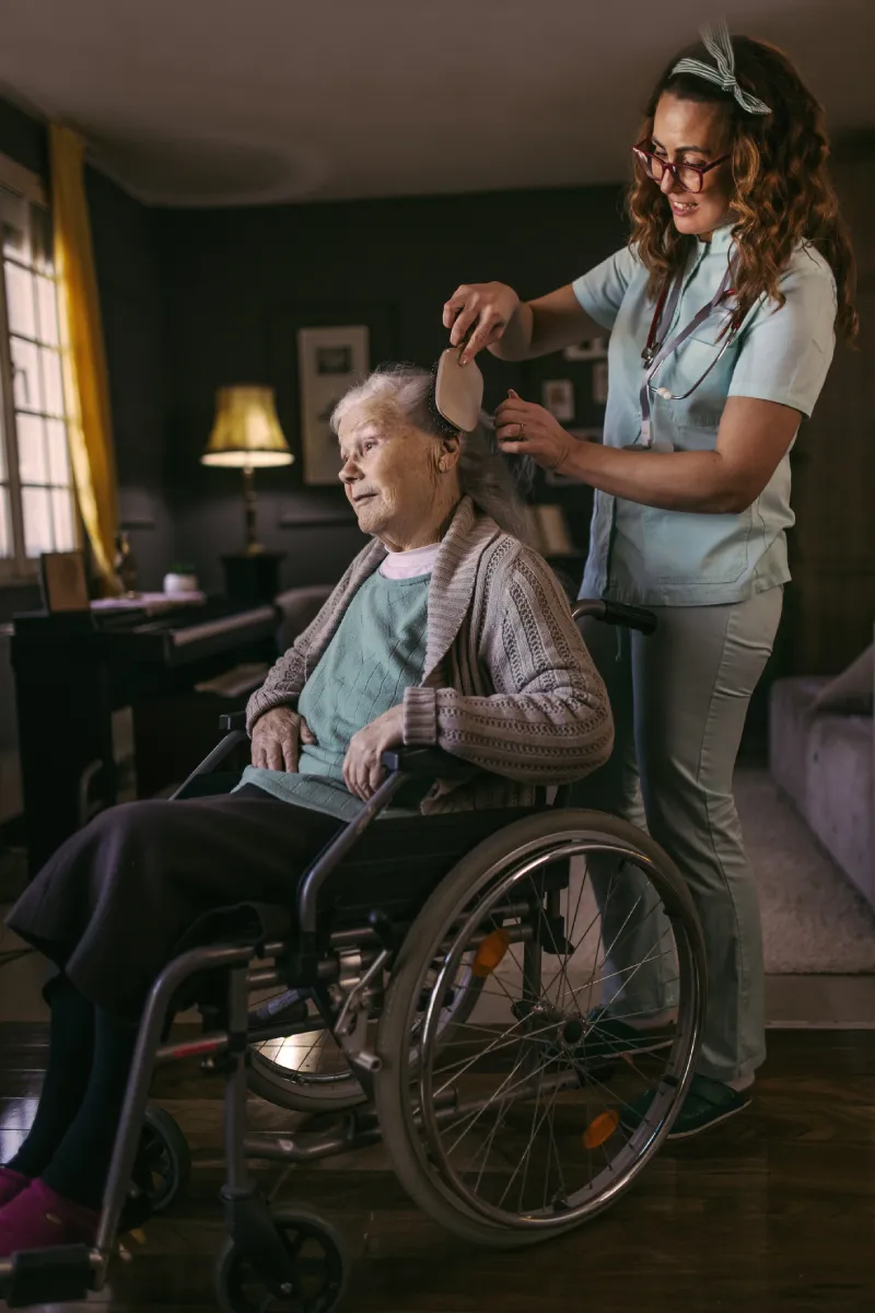 Caregiver brushing residents hair Caregiver brushing residents hair