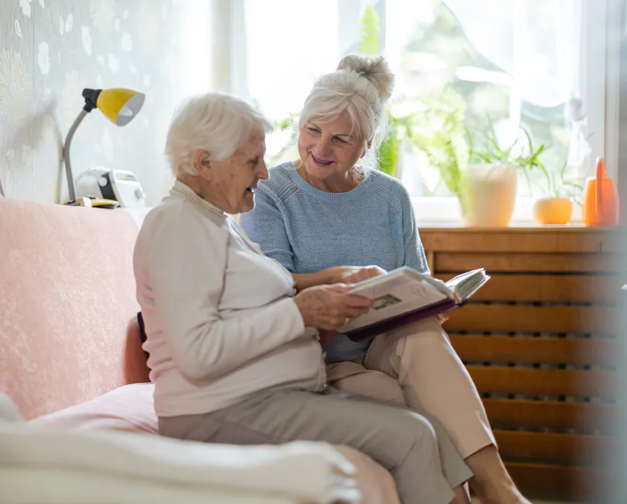 adult daughter visiting mom in assisted living