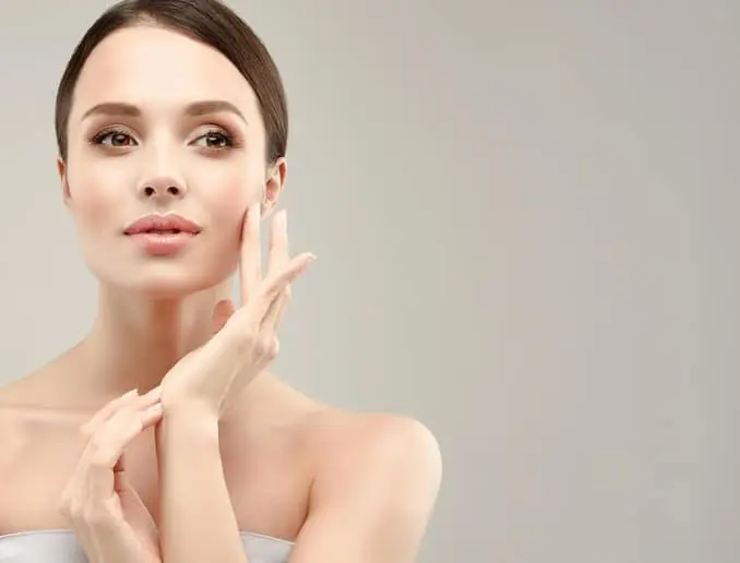 Gorgeous, young, blonde haired woman with clean fresh skin is looking straight on camera by magnetic look