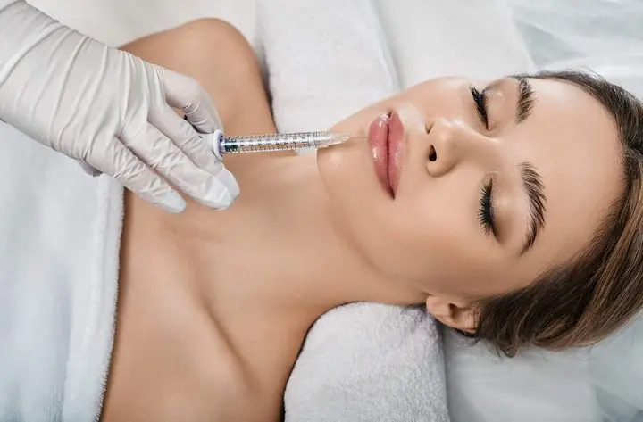 woman receives lip fillers