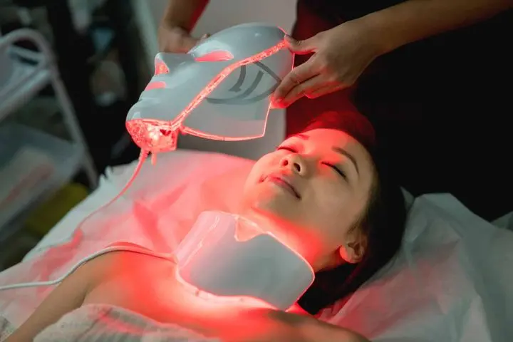 Beautiful woman at the spa getting a facial laser treatment - beauty concepts