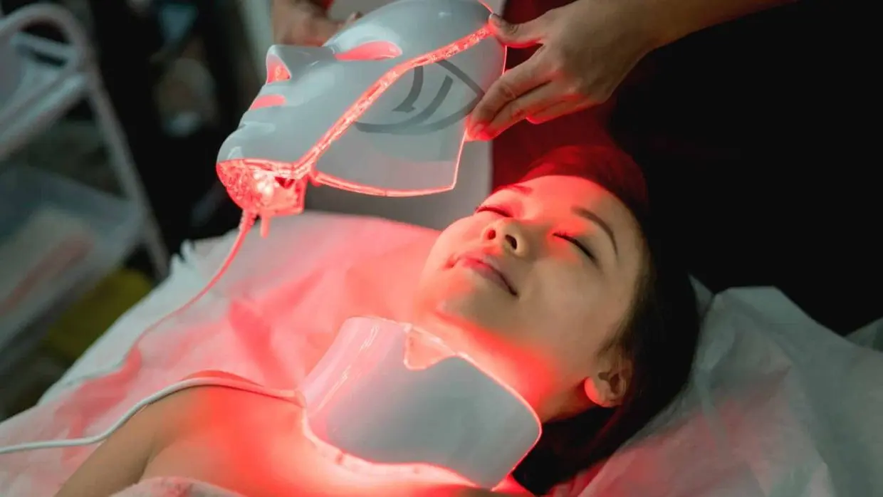 Beautiful woman at the spa getting a facial laser treatment - beauty concepts