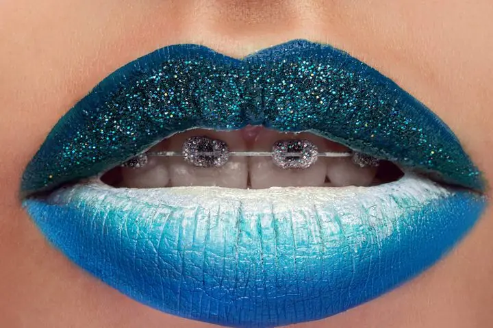 Blue lipstick. Studio close up of a woman wearing blue lipstick posing seductively with her mouth open sexuality unusual creative artistic makeup lip gloss cosmetics art creativity sexy face concept