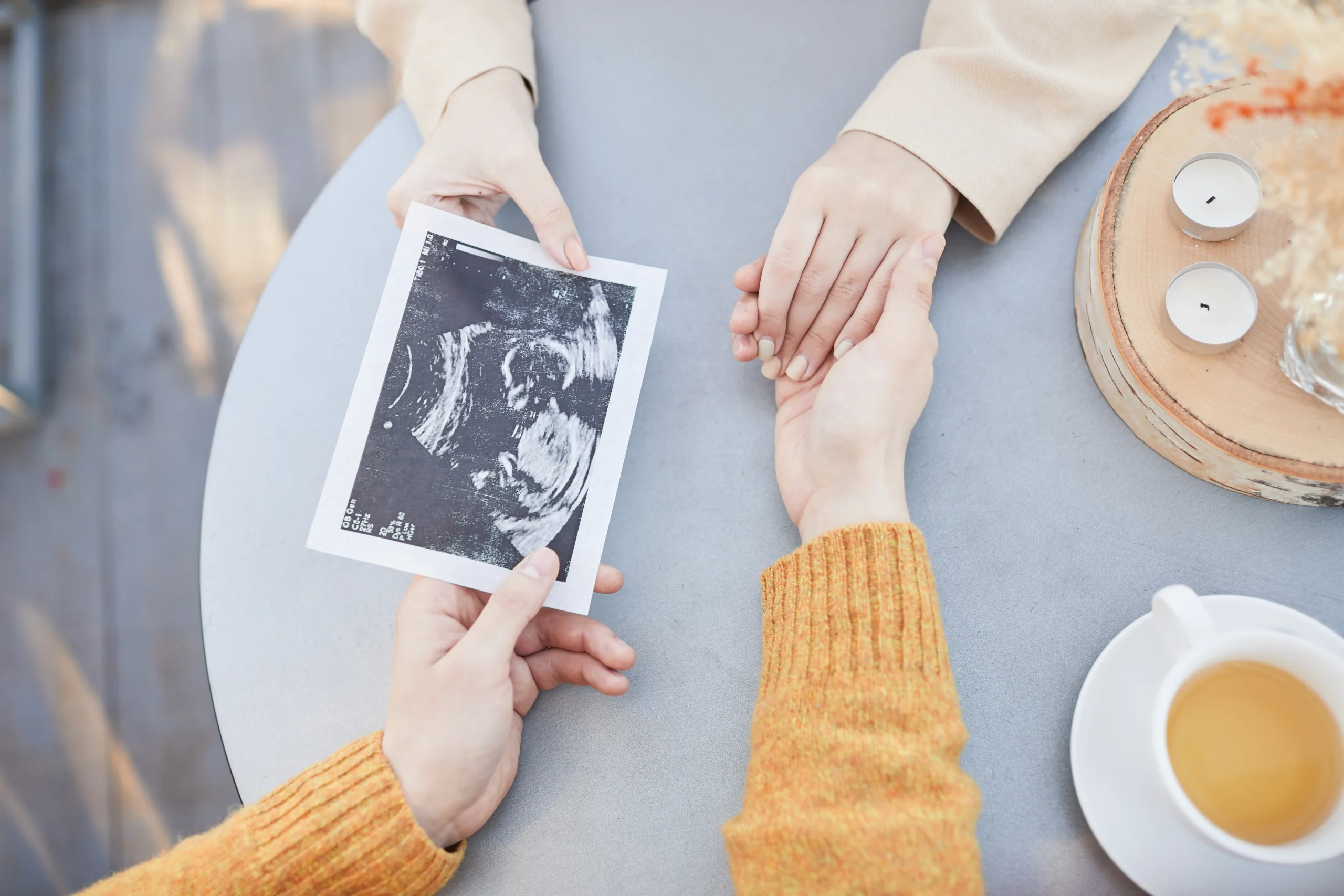 Medical 11 couple sonogram fertiliity pregnancy hands closeup intimate bright obgyn scaled