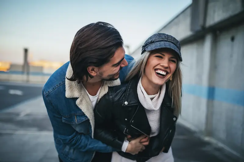 Birth Control 2 laughing-woman-with-partner-embracing-in-urban-set
