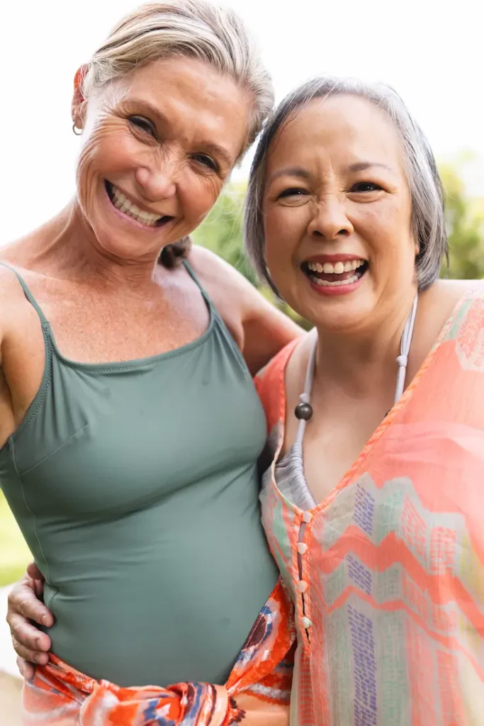 two smiling women embrace outdoors in sunlight 2026 09 22 04 24 14 utc