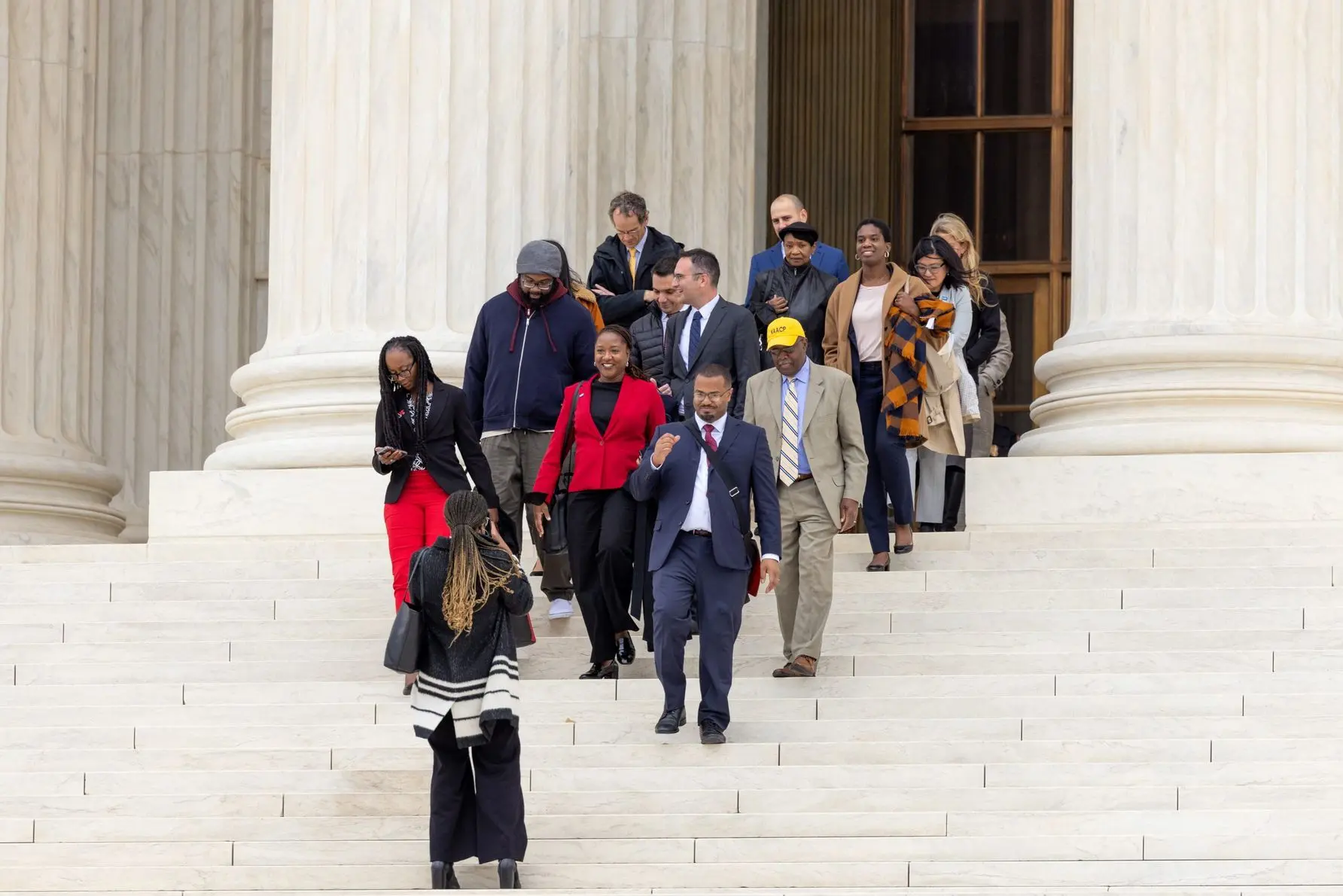 The LDF legal team, staff, and clients, exit the Supreme Court after arguments in Allen v. Milligan.