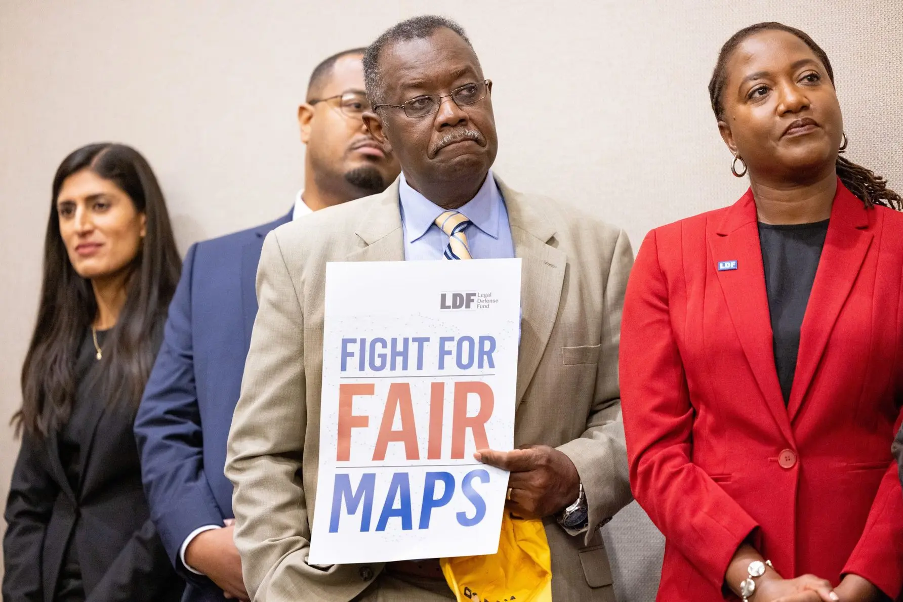 Bernard Simelton, one of the plaintiffs in Allen v. Milligan holds a sign during a press conference following arguments in the case. Photo by Allison Shelley for LDF.