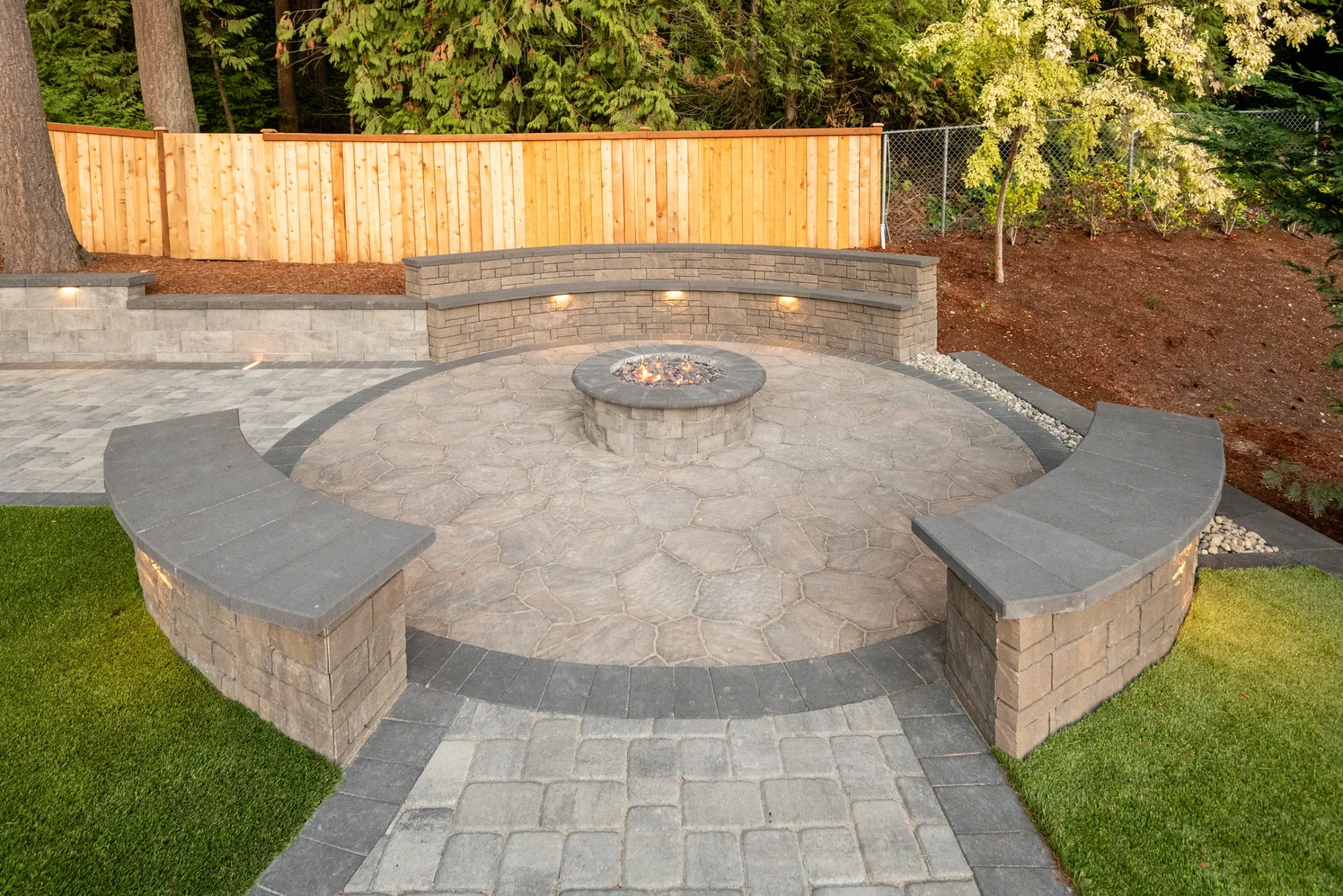 Circular fire pit area set within the Kirkland paver patio