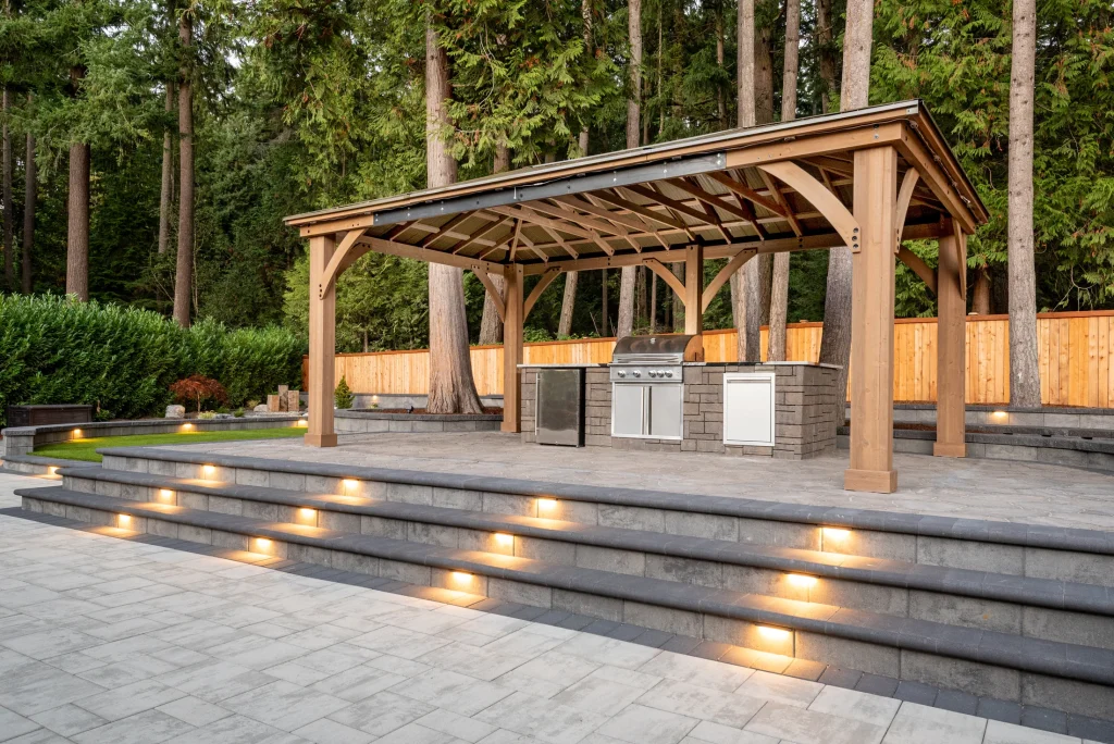 Pergola-covered outdoor kitchen and lighted paver steps in Kirkland, Washington