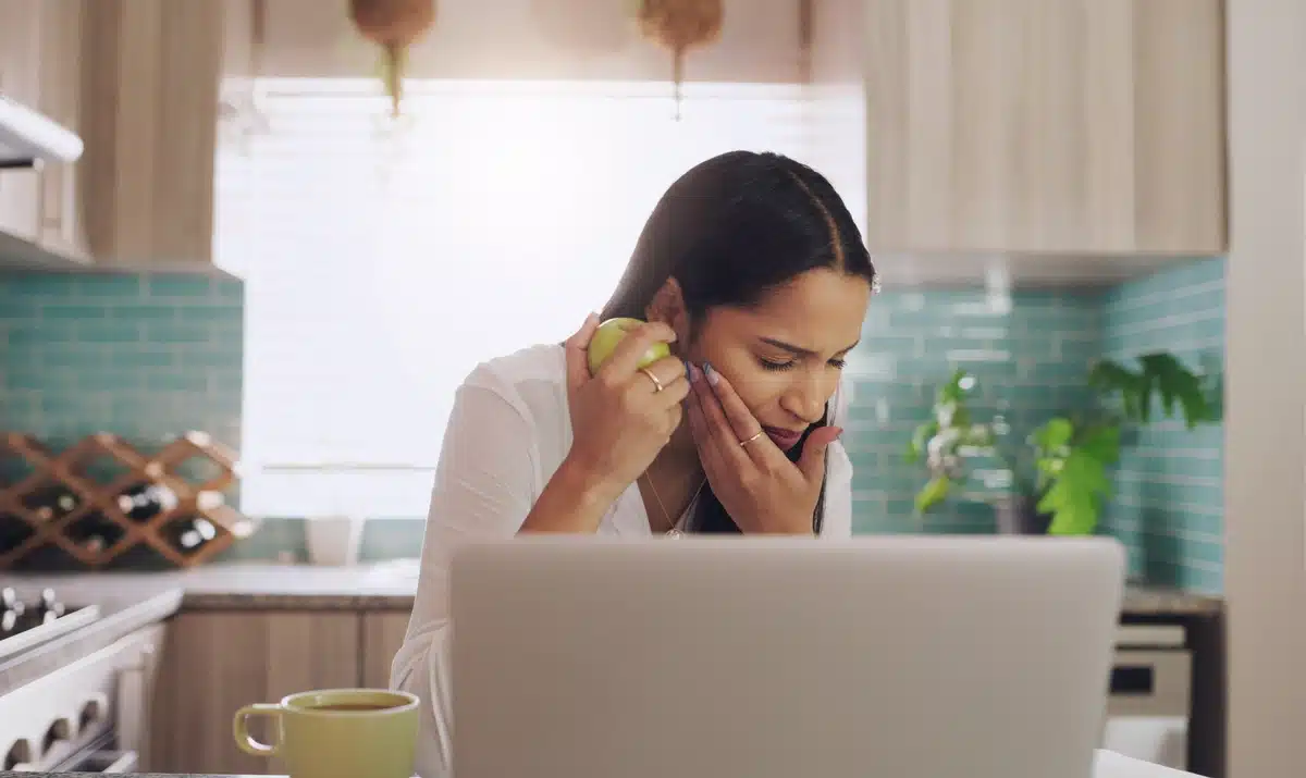 woman having toothache at home