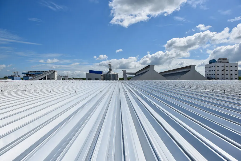 closeup of grey metal roof installation on new build