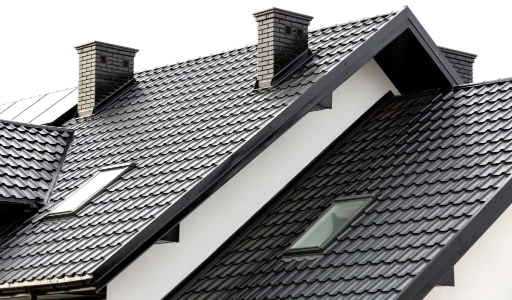 a white house with black metal tile roof