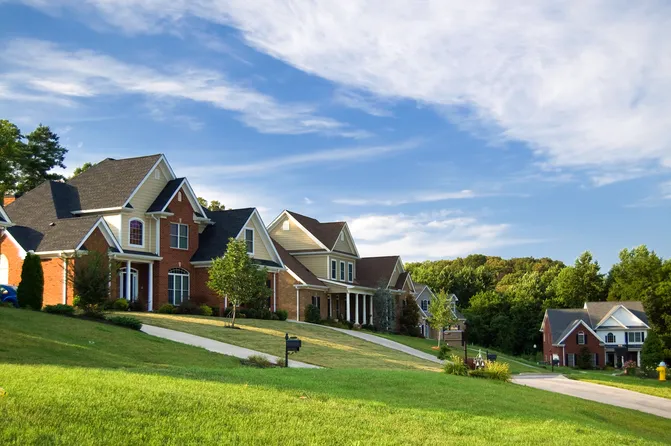 Neighborhood street in indiana with nice suburban homes with new roofs